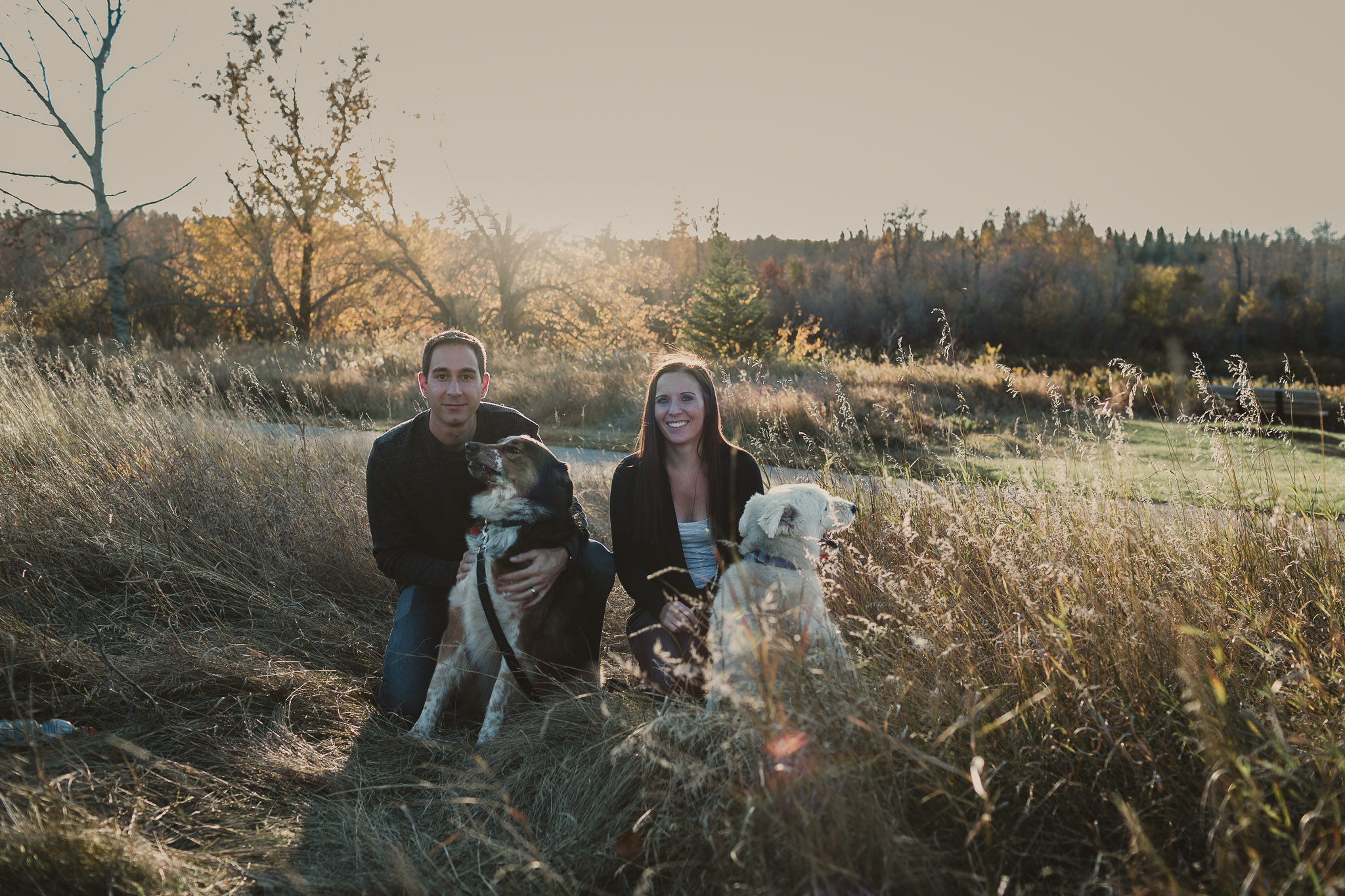 man and woman with two dogs