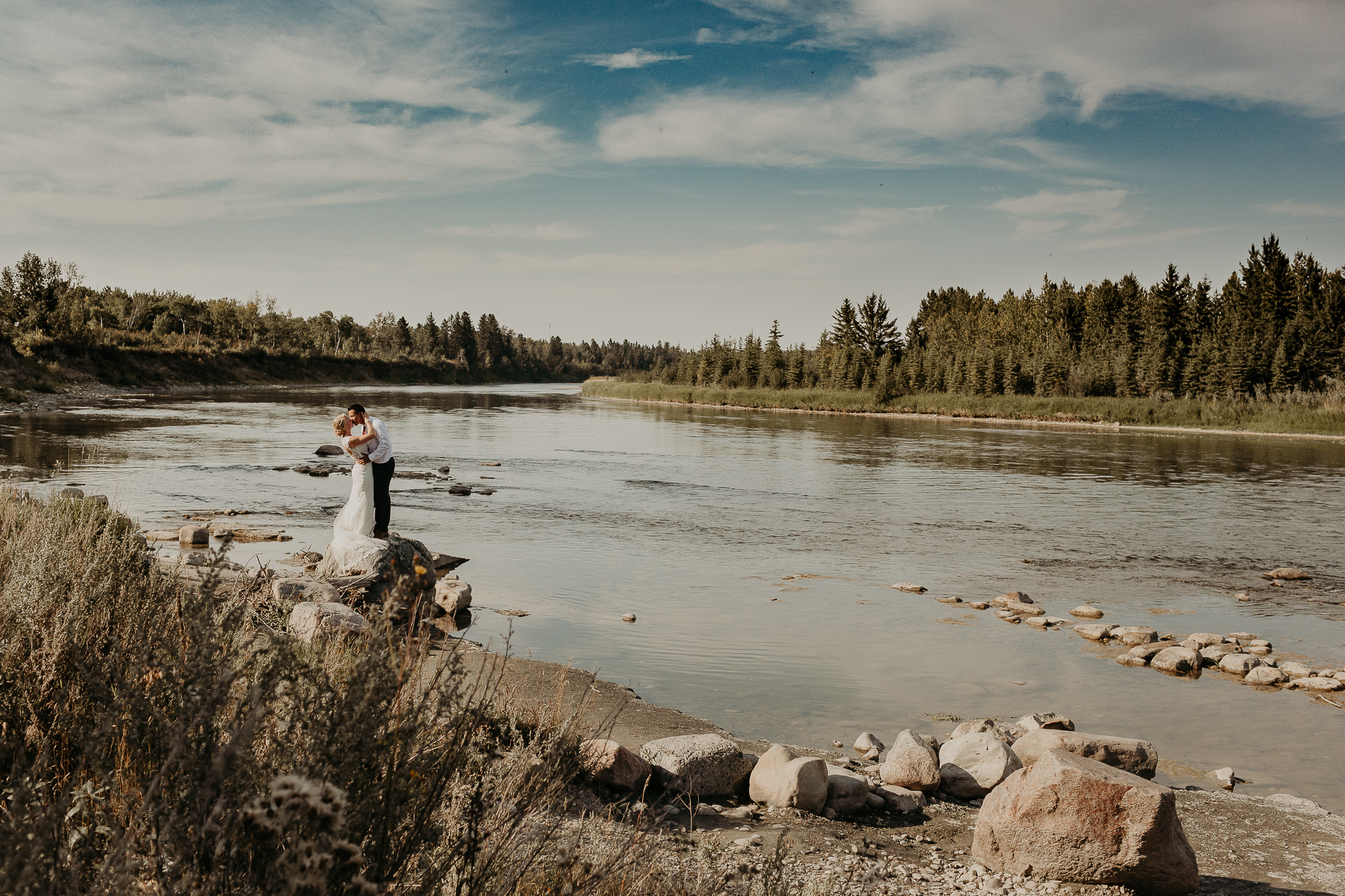 couple kissing by a river