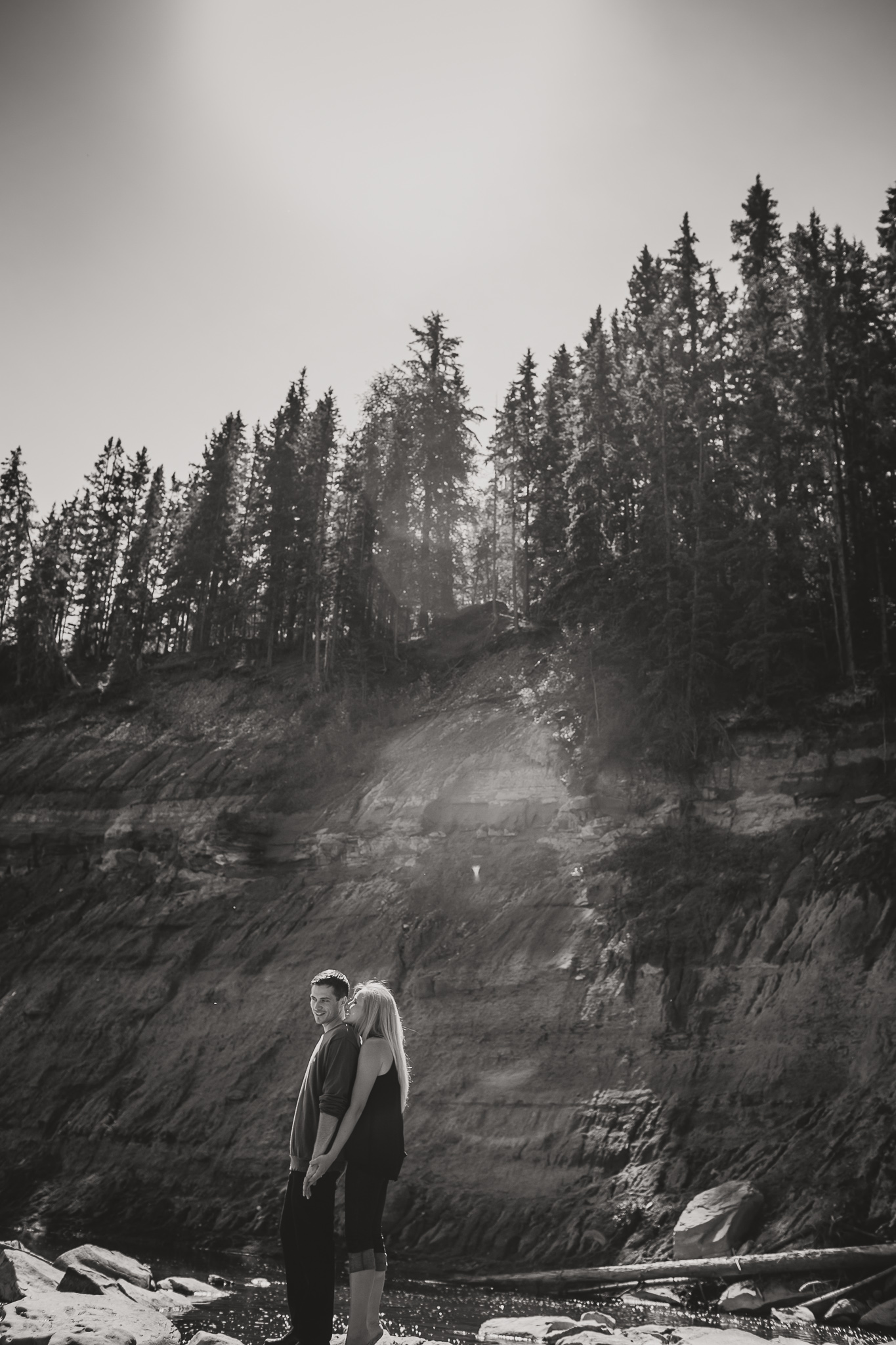 couple standing on a rock in the river