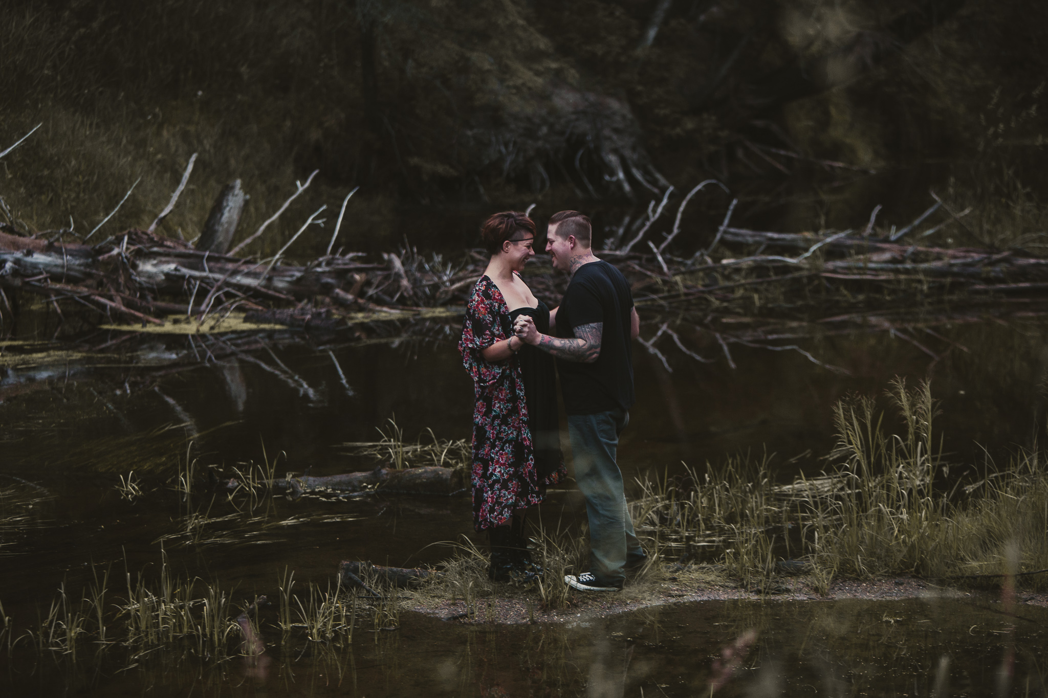 man and woman dancing by a creek