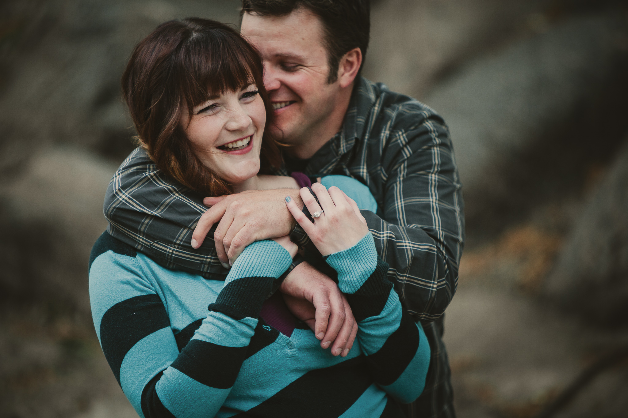 man holding woman from behind and laughing