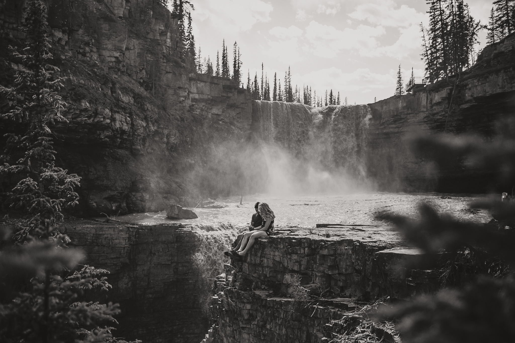 couple sitting by a waterfall