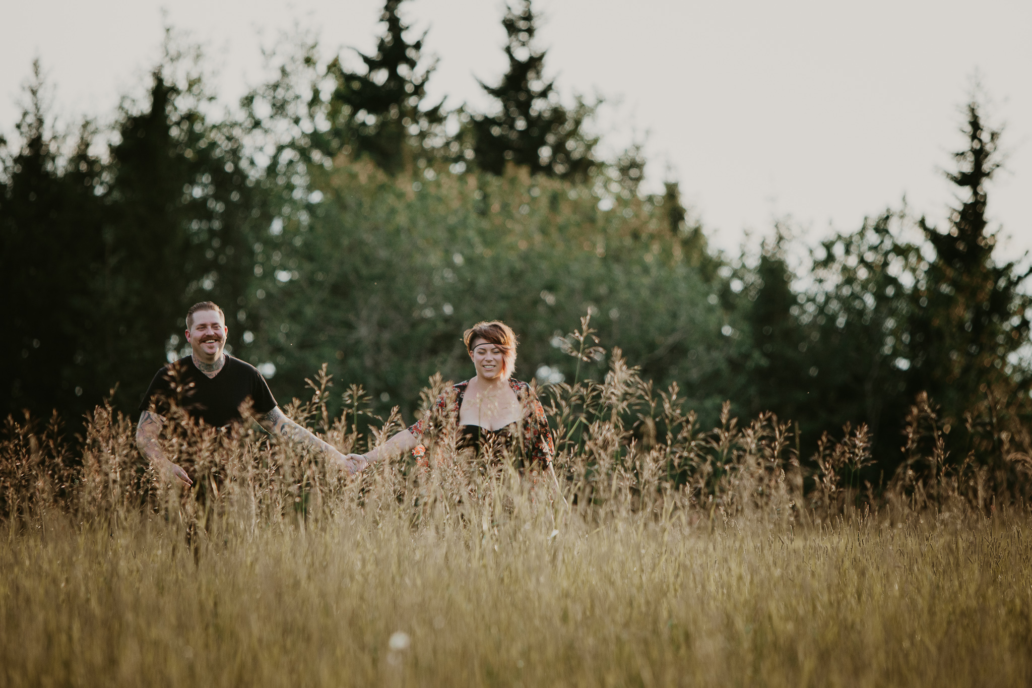 man and woman standing in long grass