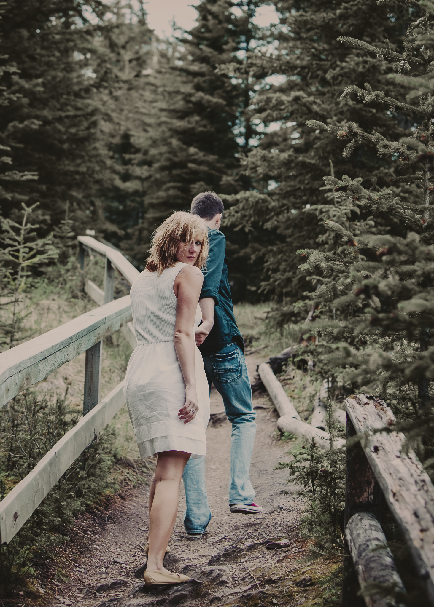 MAN WALKING UP HILL HOLDING WOMANS HAND