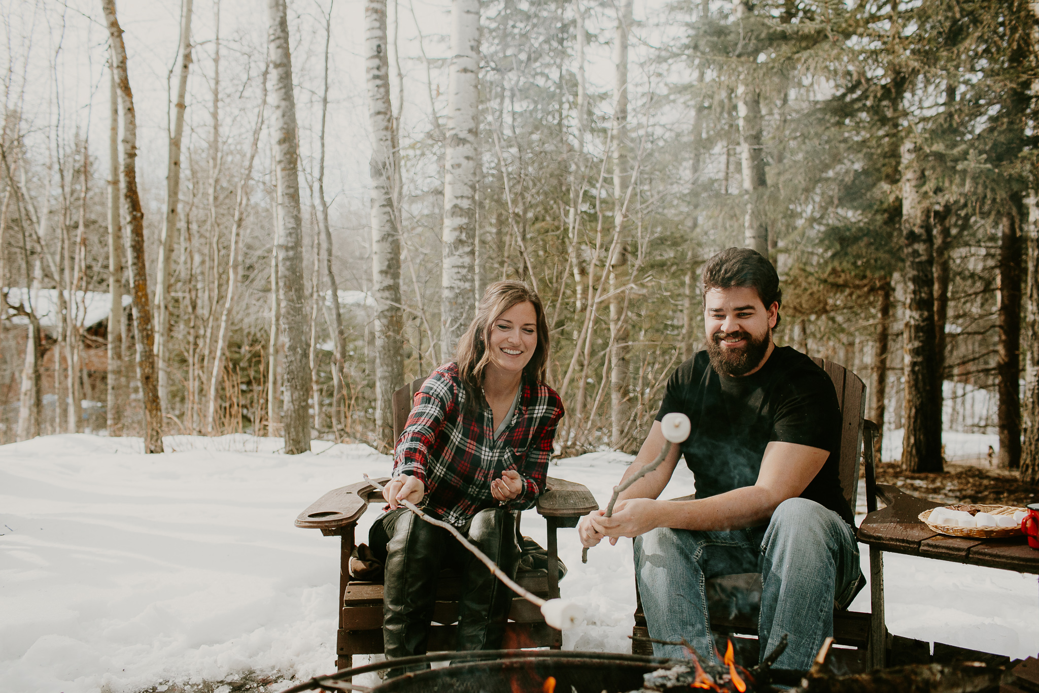 man and woman roasting marshmallows
