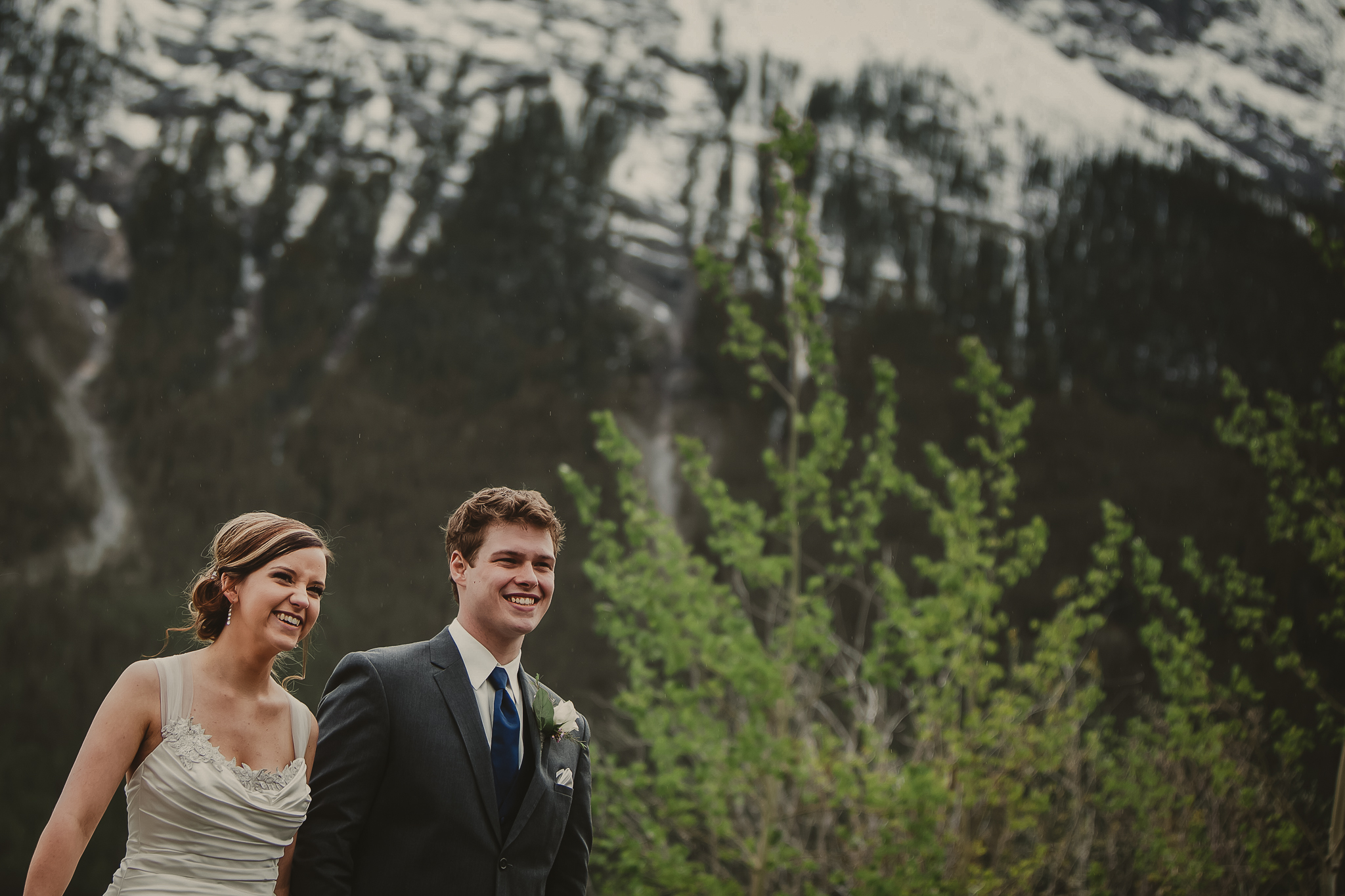 wedding couple walking in the mountains and laughing