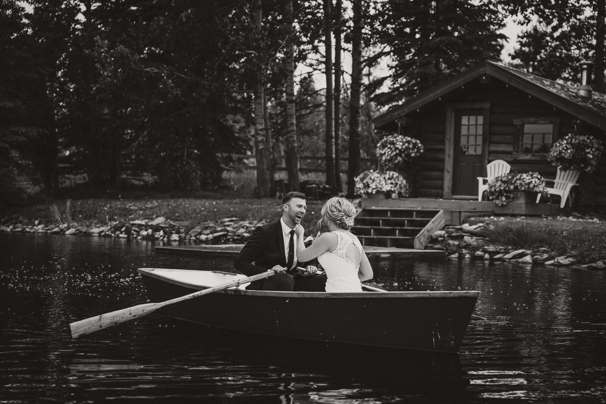 black and white wedding couple in a row boat