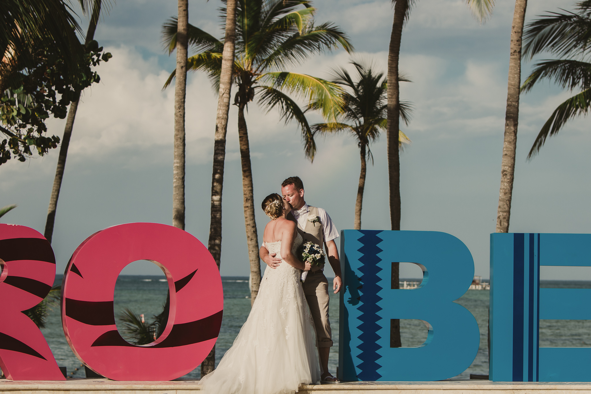bride and groom standing by sign in dominican