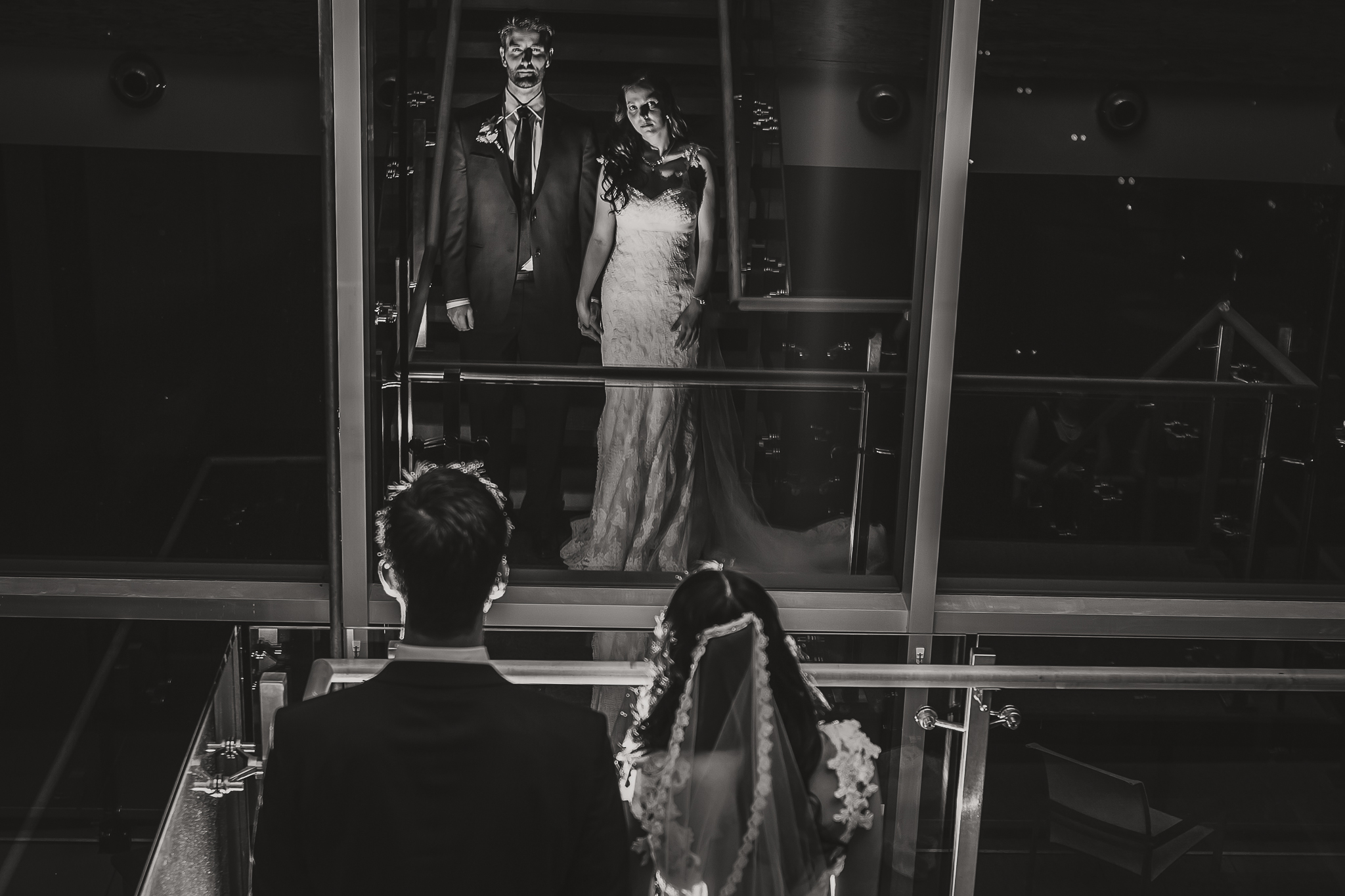 bride and groom looking in a mirror