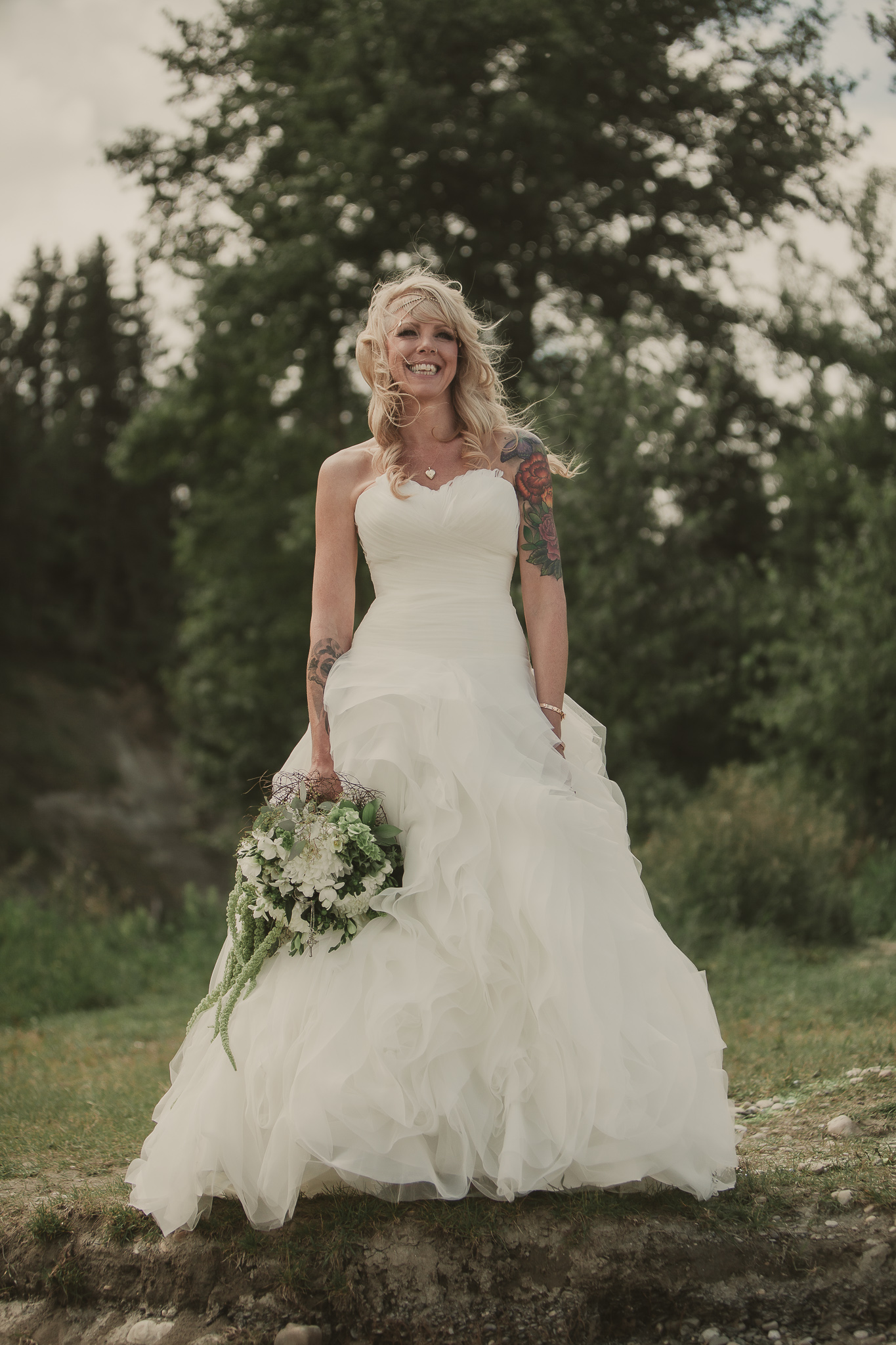 bride smiling on the rivers edge
