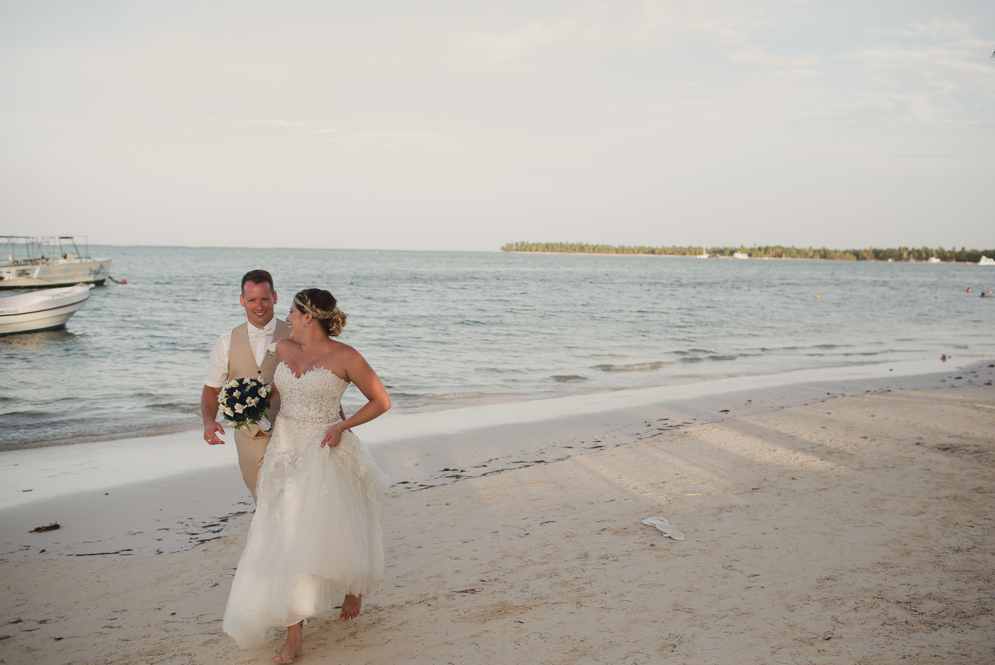 bride and man running on a beach