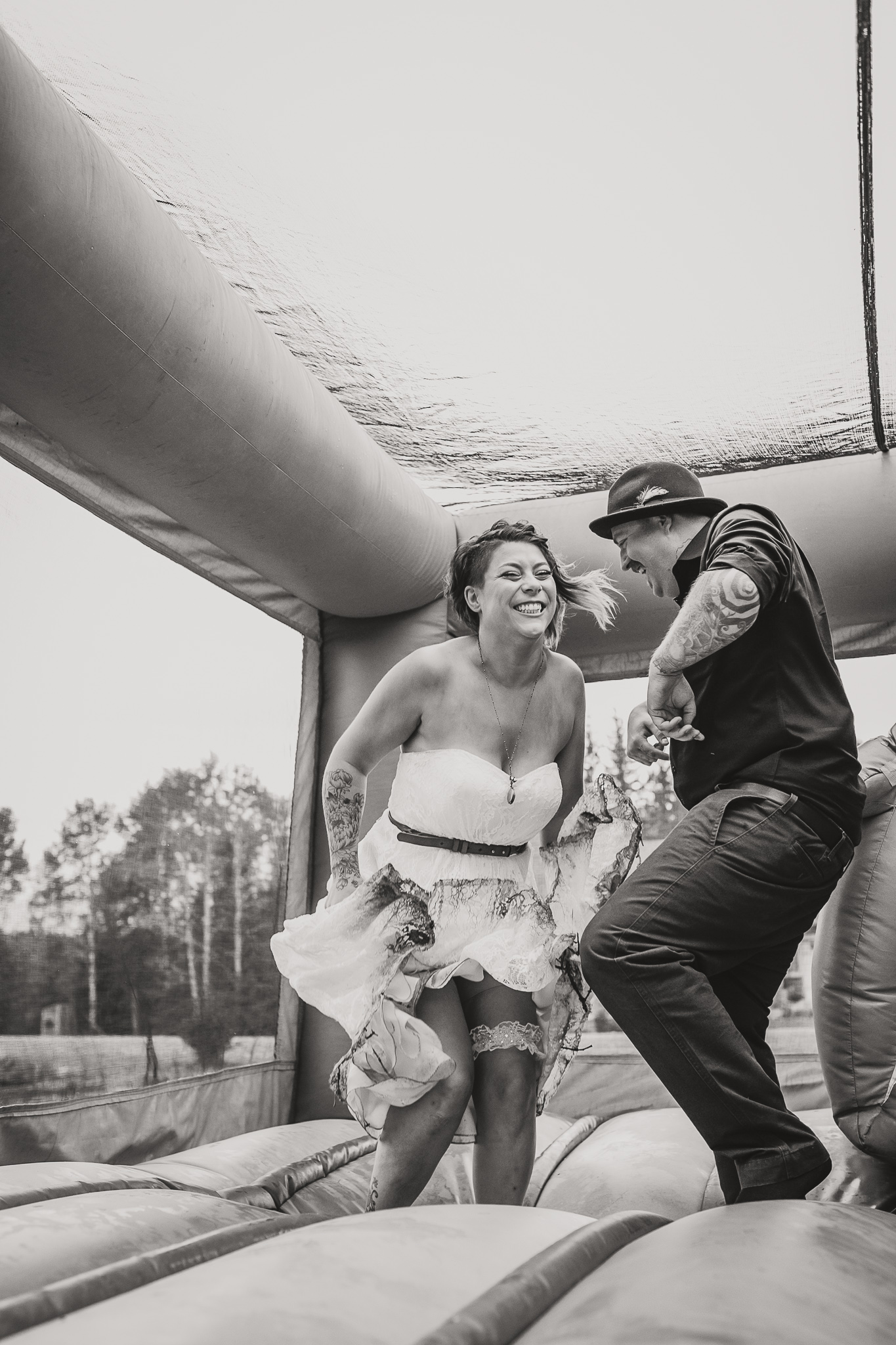 two adults bouncing in a bouncy castle