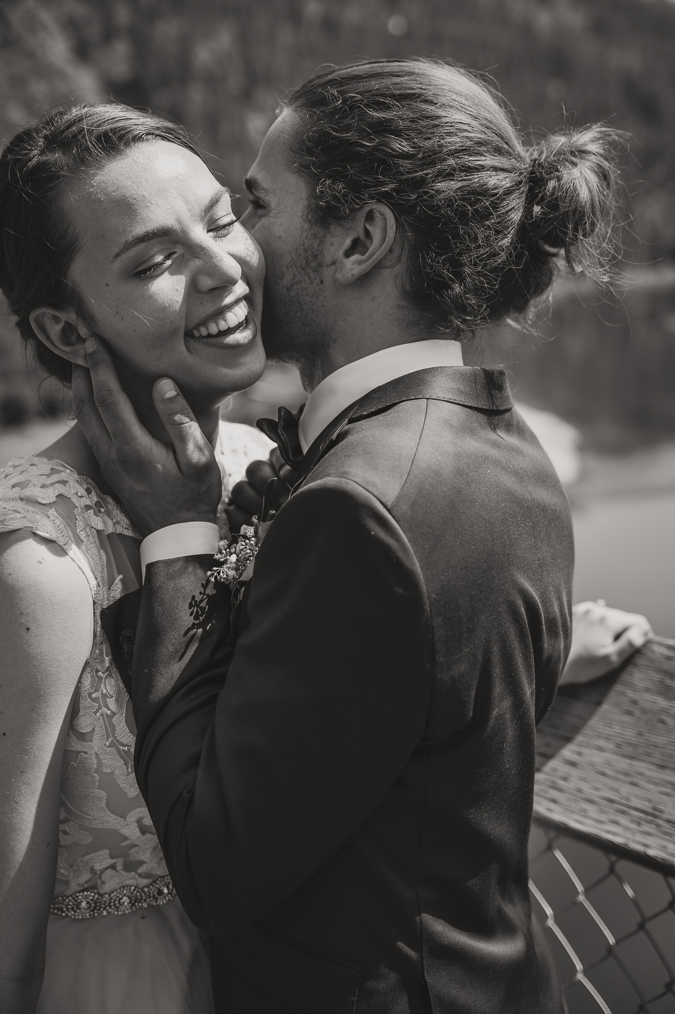 man and woman in a laughing embrace