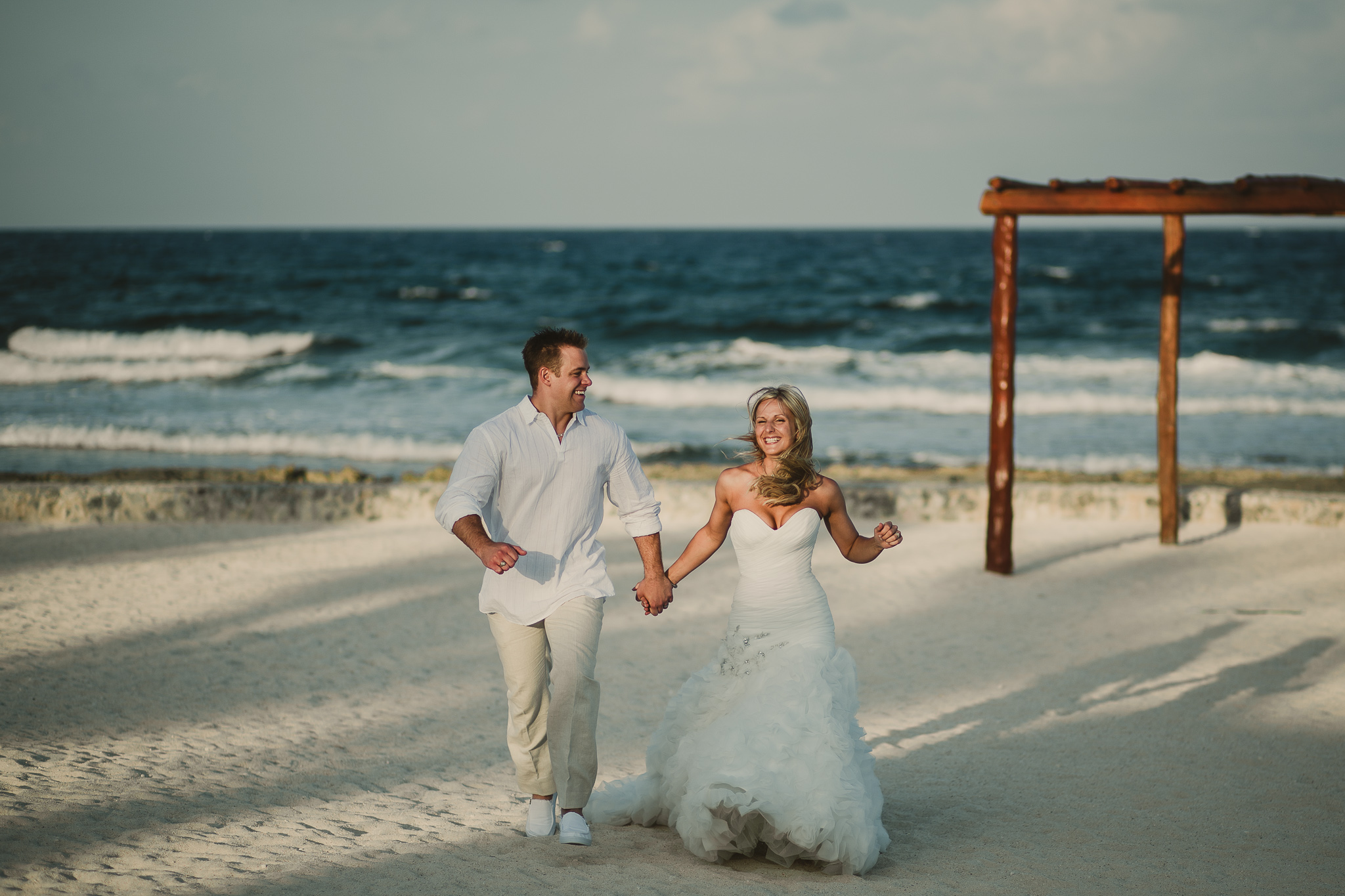 wedding couple running on the beach