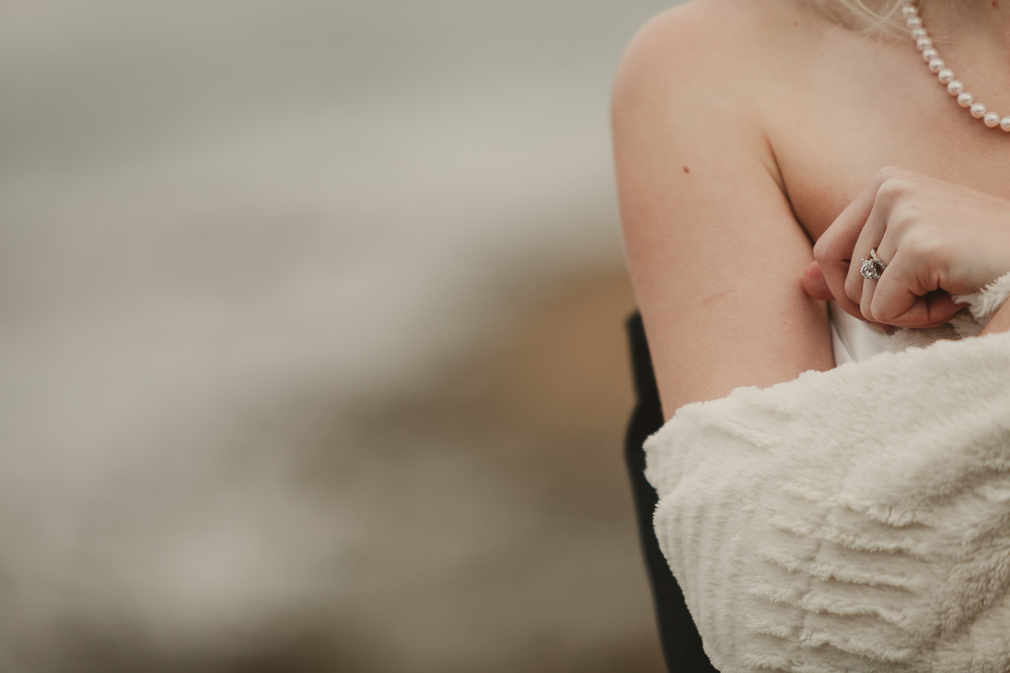 woman's shoulder and pearl necklace