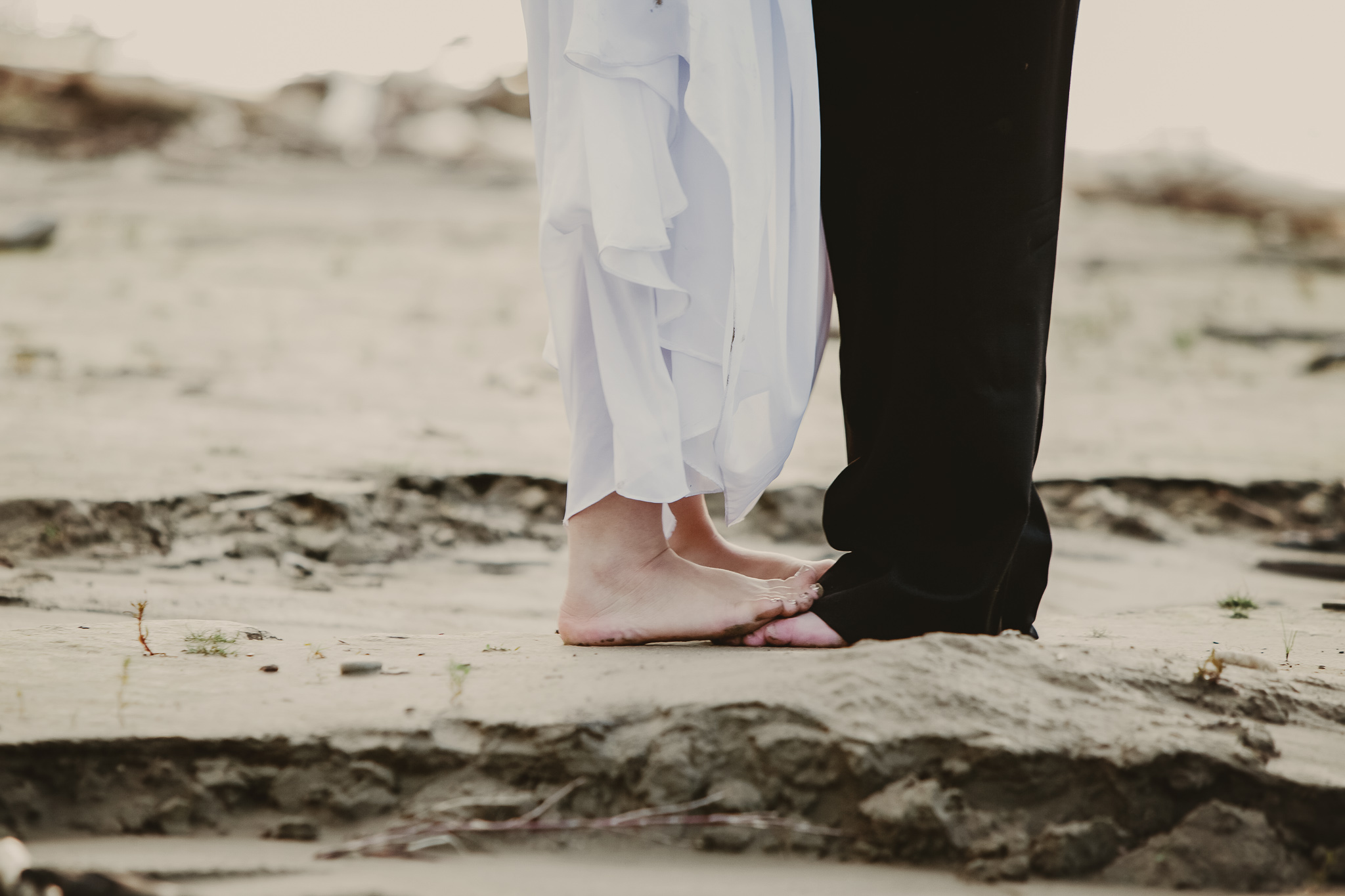 two sets of feet on the beach