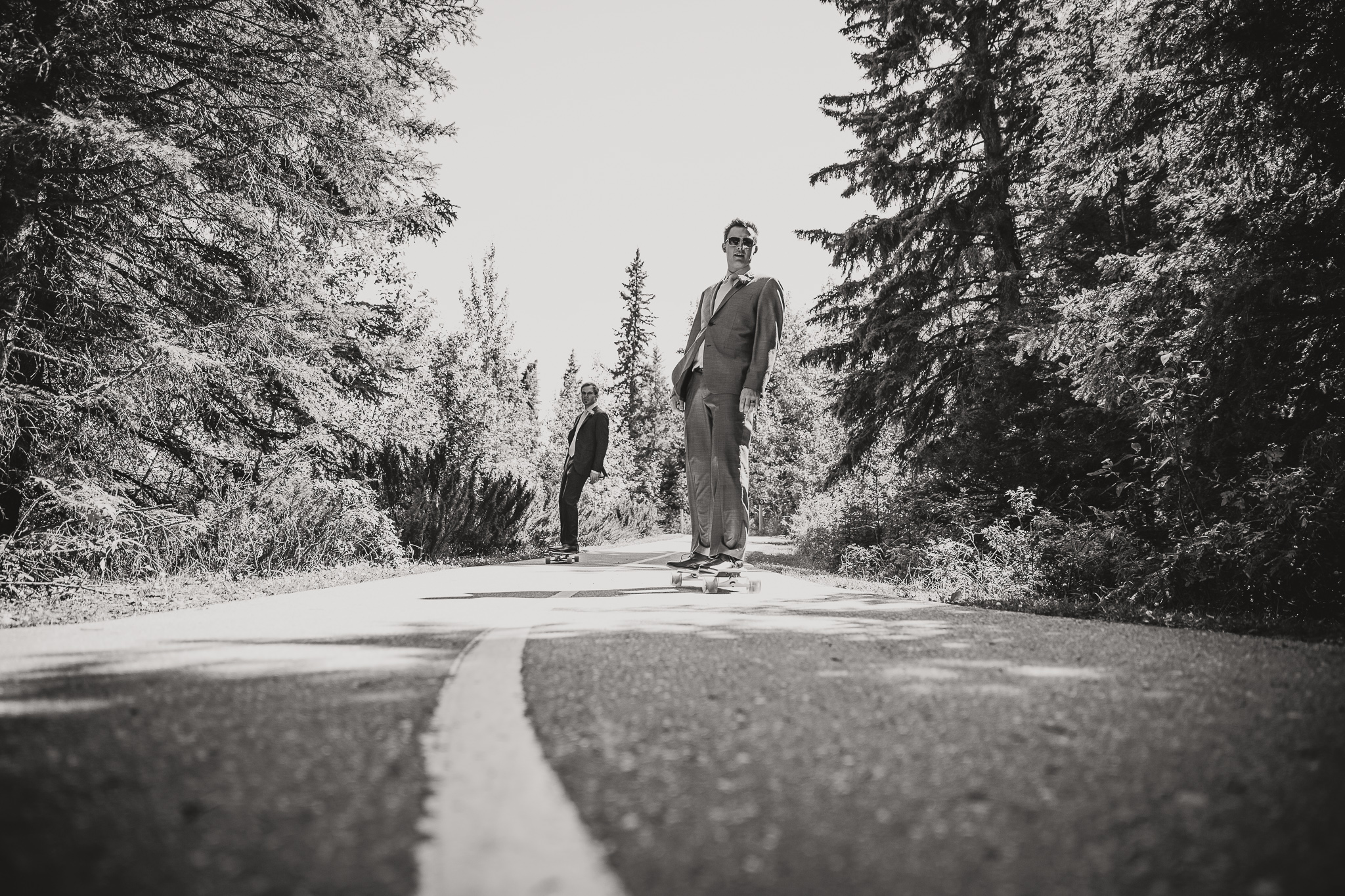 two men in suits skateboarding