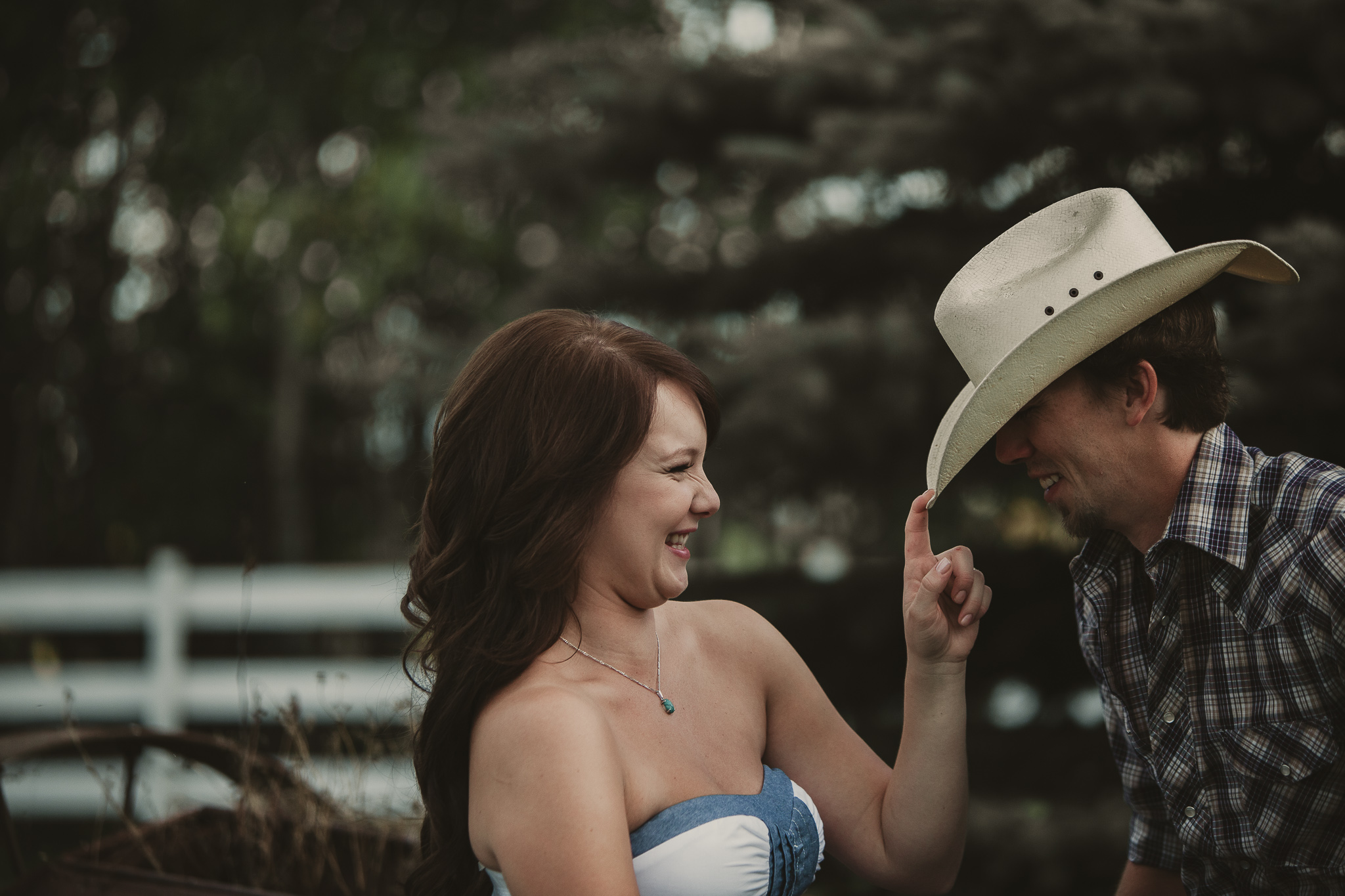 woman tips mans cowboy hat