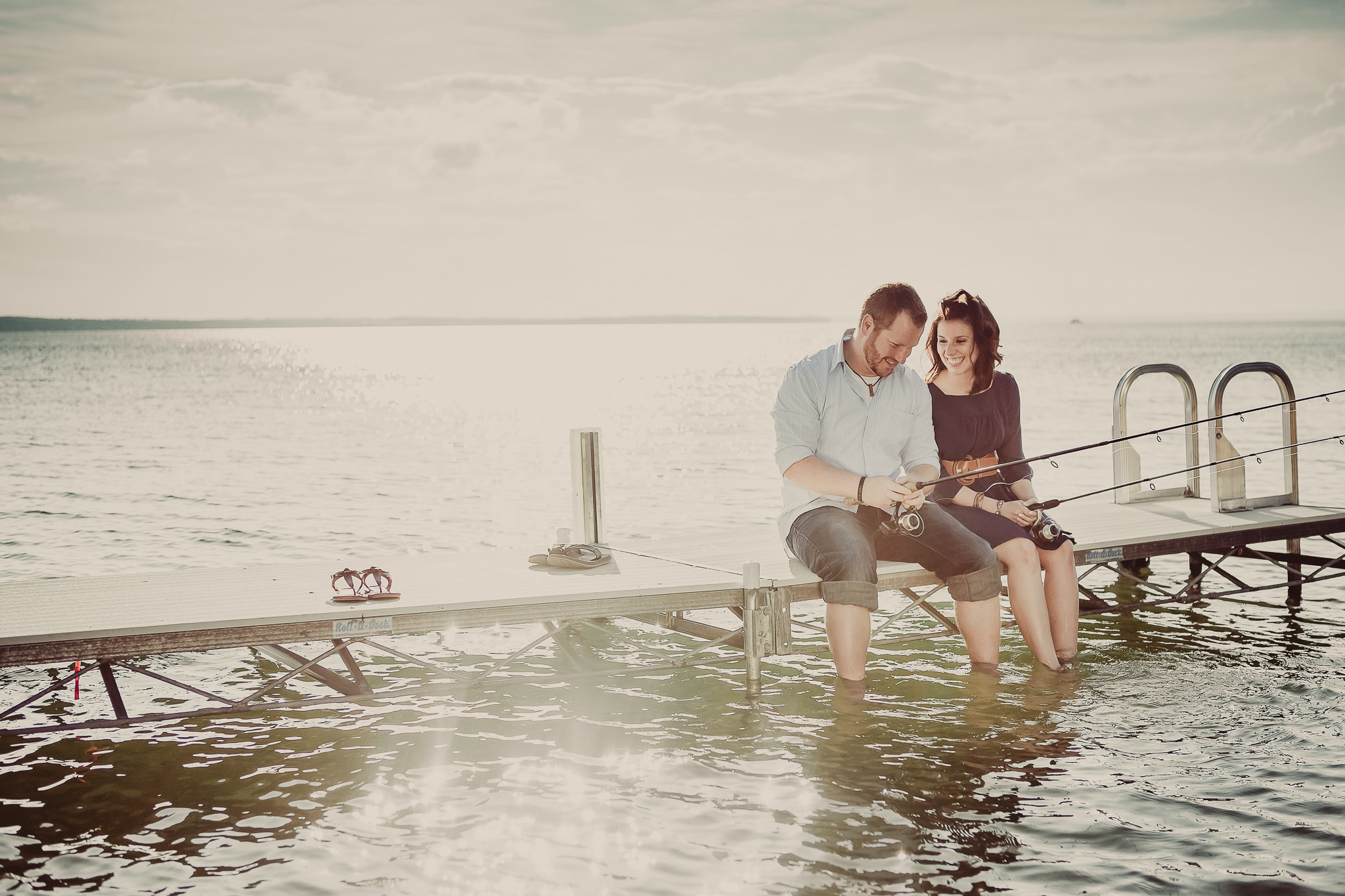 man and woman fish on a dock